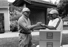 Tony Simons presents a check to Milbank Tennis Association